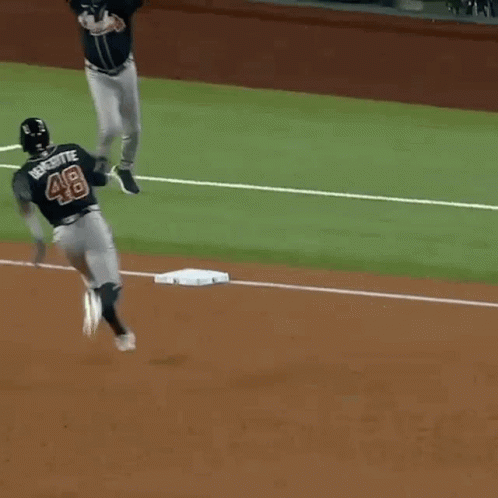 Baseball Player Number 48 Running to Base