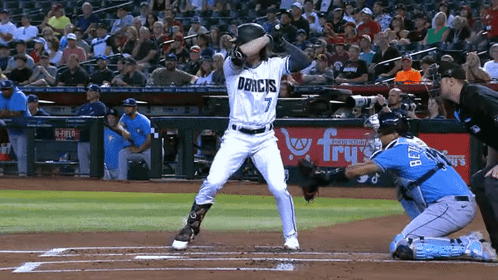 Baseball Player Number 7 Swinging at Ball