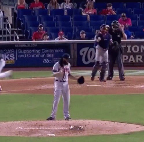 Baseball Player On Mound In Front Of Nationals Banner GIF