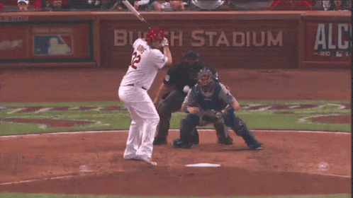 Baseball Player Reaching for Bat Budweiser Sign