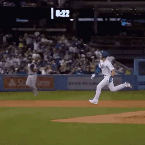 Baseball Player Running to Catch Ball, Another Watches