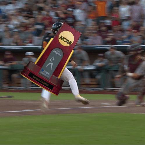 Baseball Player Running With NCAA Trophy