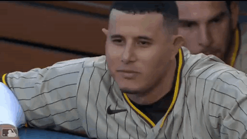 Baseball Player Sitting in Striped Jersey
