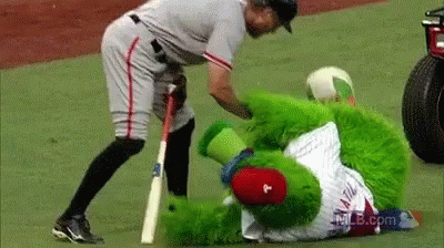 Baseball Player Standing Next To Green Mascot With Letter P GIF