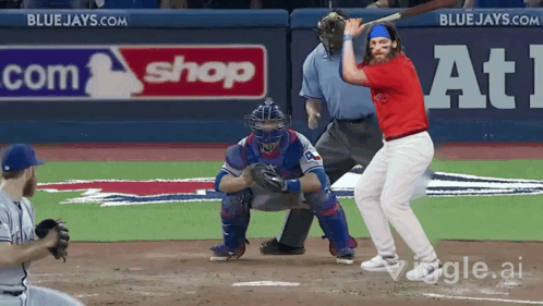 Baseball Player Swinging At Ball In Front Of Blue Jays Sign GIF