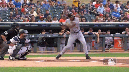 Baseball Player Swinging at Pitch Near Gatorade Sign