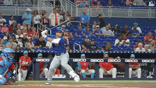 Baseball Player Swinging at Pitch with Geico Banner