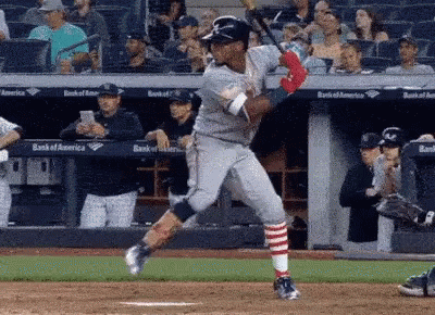 Baseball Player Swinging Bat at Ball With Crowd Watching