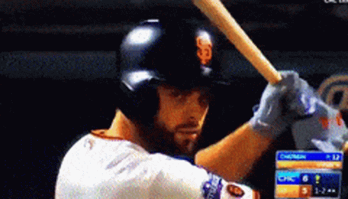Baseball Player Swinging Bat in Front of Chasers Scoreboard