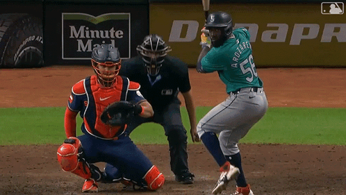 Baseball Player Swinging Bat in Front of Duke Energy Banner