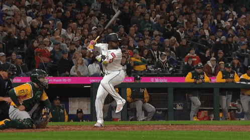 Baseball Player Swinging Bat in Front of T-Mobile Sponsored Crowd