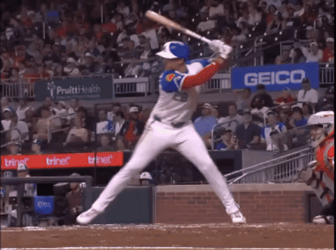 Baseball Player Swinging Near Geico Sign