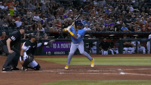 Baseball Player Swings at Pitch With 10 a Month Sign