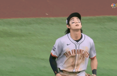 Baseball Player Throwing Ball in Front of Sub Above Sign