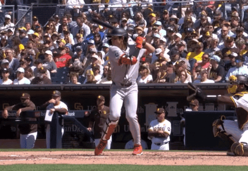 Baseball Player Throwing Ball in Front of Sub Above Sign