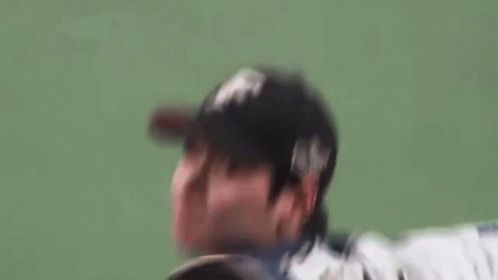 Baseball Player Throwing Ball on Green Field