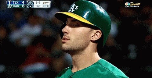 Baseball Player Wearing Green and Yellow A's Cap