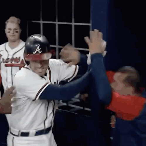 Baseball Player With A On Helmet High Five