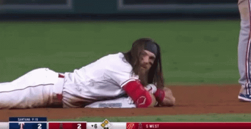 Baseball Player With Long Hair Lying On Ground GIF
