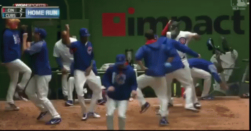 Baseball Players Dancing in Front of Home Run Sign