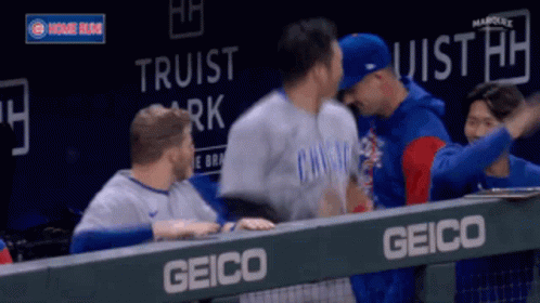 Baseball Players Hugging Behind Fence