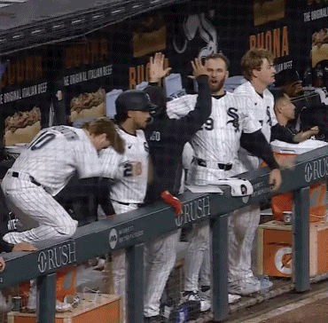 Baseball Players in Dugout With Rush Sign