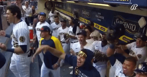 Baseball Players in Dugout with Sabretto Sign