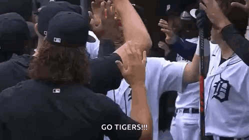 Baseball Players in Huddle Giving High Fives