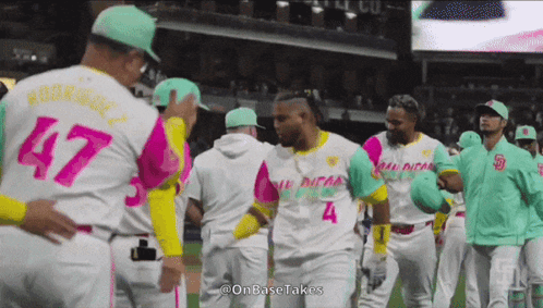 Baseball Players in Pink and Green Uniforms