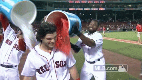 Baseball Players In Red Sox Uniforms Pouring Red Powder GIF