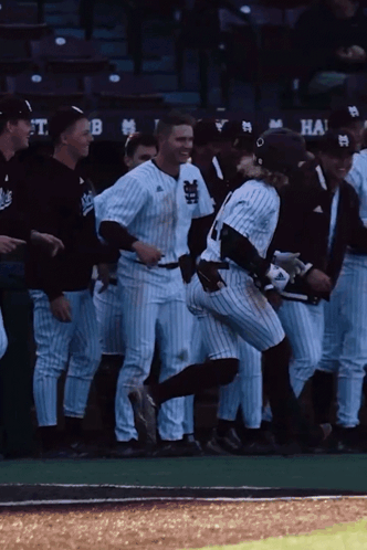 Baseball Players on Field with Dugout Saying T.B