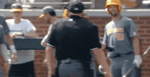 Baseball Players Standing in Front of Brick Wall