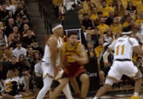 Basketball Game in Front of Crowd With Care Sign