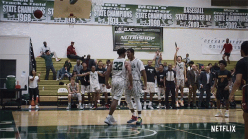 Basketball Game In Front Of Nutrishop Banner