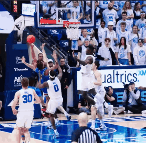 Basketball Game in Front of Qualtrics XM Sign