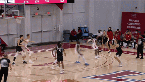 Basketball Game in Front of Selfless Sign