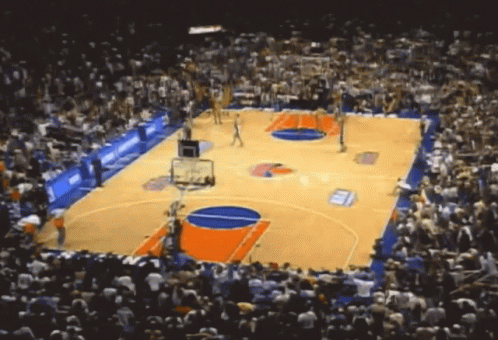 Basketball Game in Stadium with Crowd