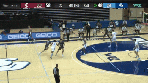Basketball Game on Court with Geico Sign