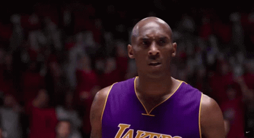 Basketball Player Covering Ears in Purple Lakers Jersey
