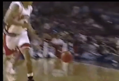 Basketball Player Dribbling in Front of Crowd
