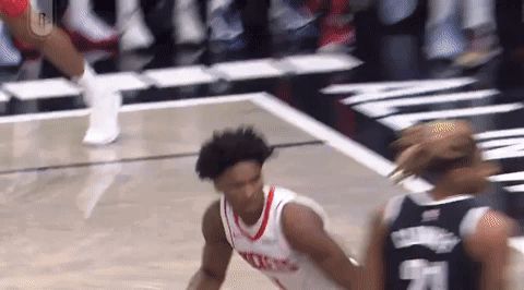 Basketball Player Dribbling Past Defender