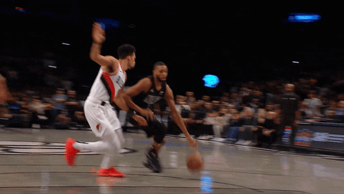 Basketball Player Dribbling While Another Watches