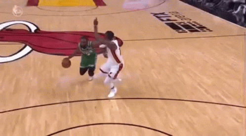 Basketball Player Dunking Over Defender