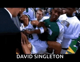 Basketball Player Held Up by Man in Suit David Singleton