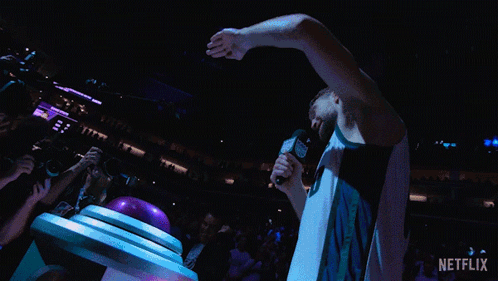Basketball Player Holding Microphone In Crowd GIF