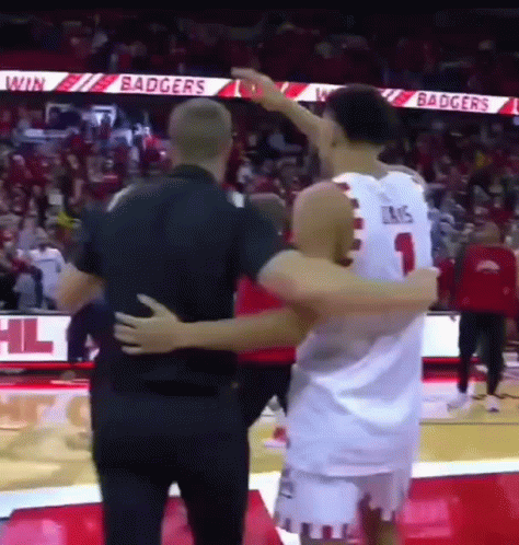 Basketball Player Hugging Another Player on Court