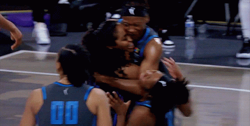Basketball Player in 00 Jersey Hugged by Teammates