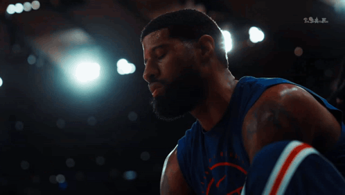 Basketball Player in Blue Jersey Looking Down