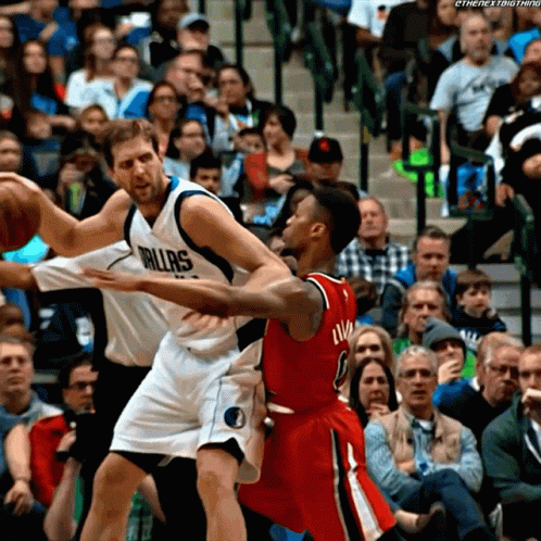 Basketball Player in Dallas Jersey Blocking Another