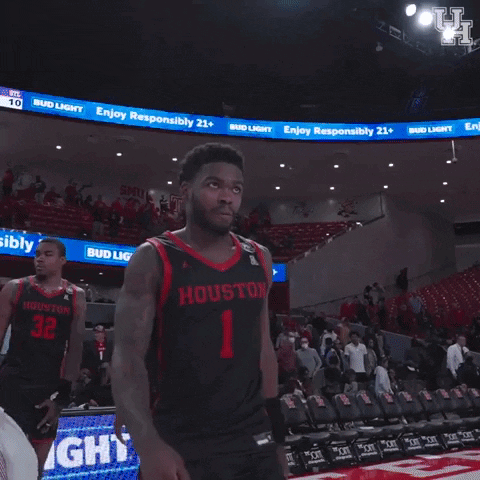 Basketball Player in Houston Jersey Standing on Court